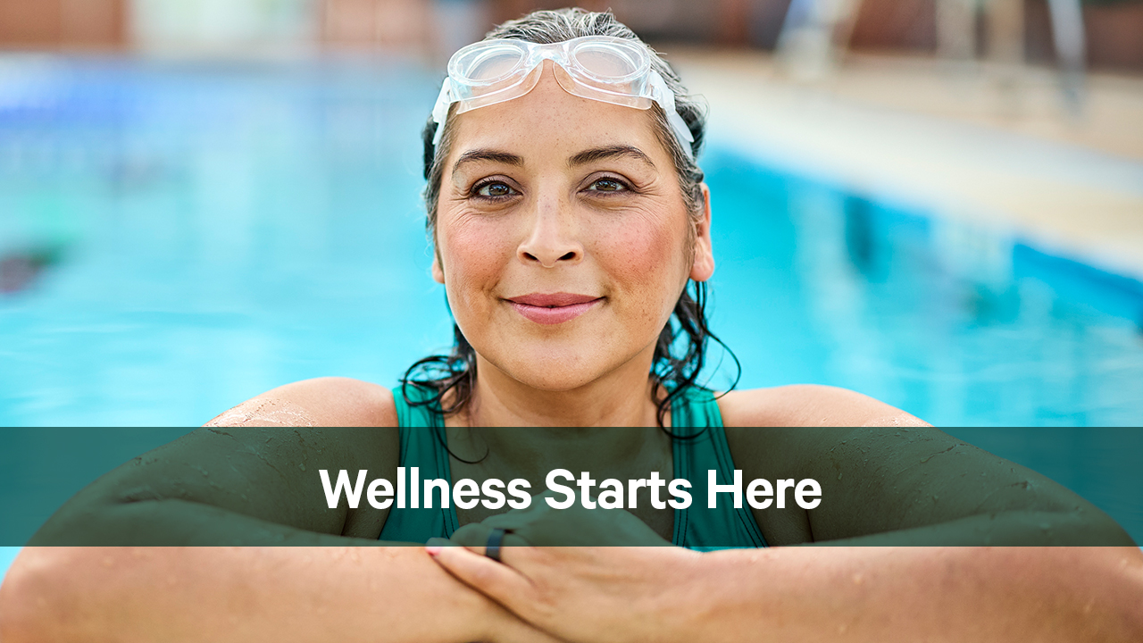 Woman smiles at a swimming pool