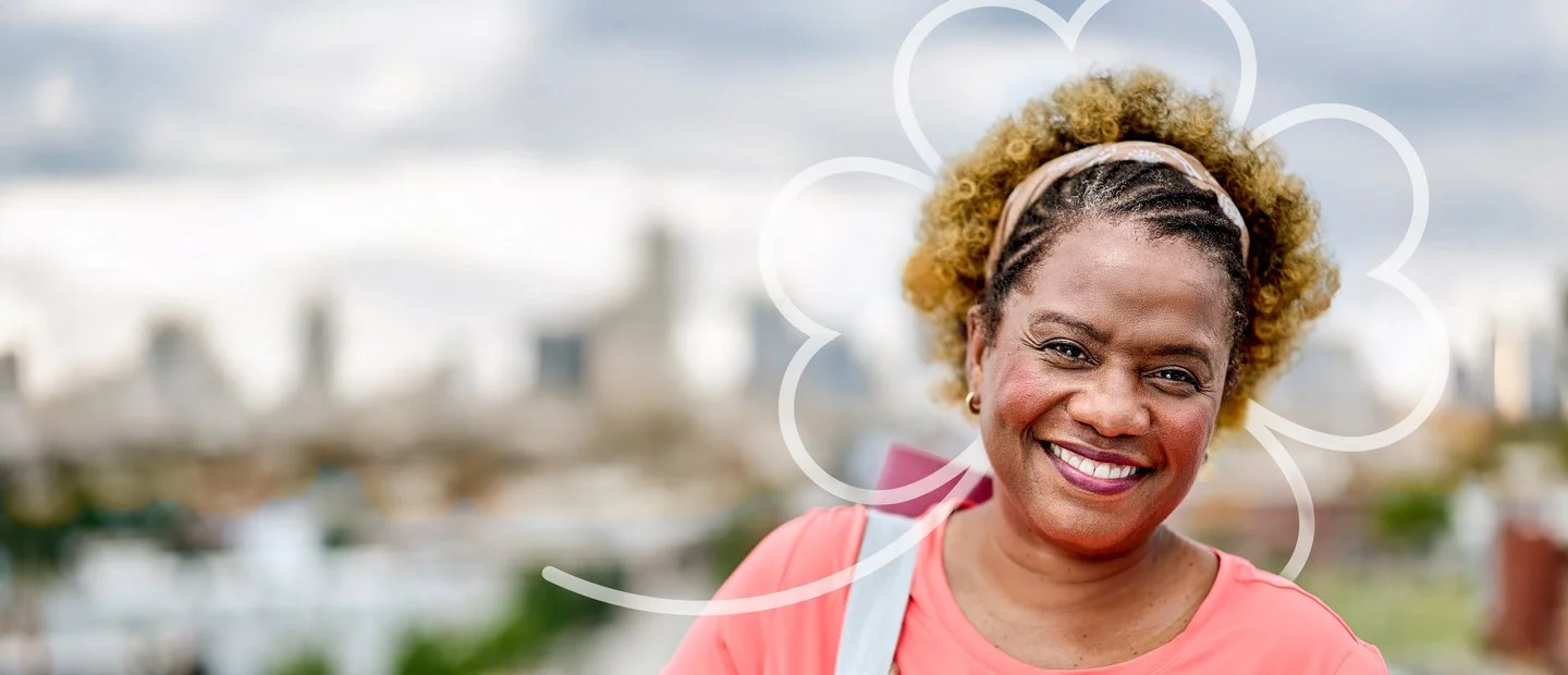 Woman smiling in a pink sweater.